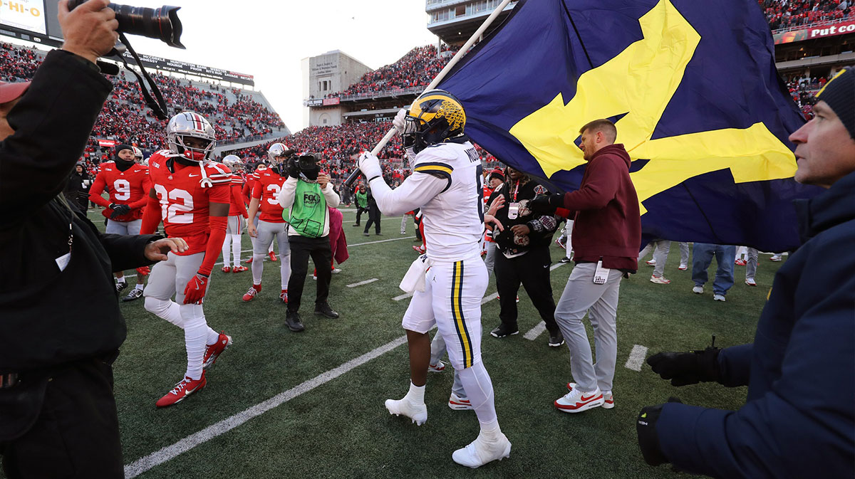 Michigan Wolverines defensive end Derrick Moore (8) attempts to plant the flag on the Ohio State Buckeyes logo as Ohio State Buckeyes defensive end Jack Sawyer (33) rips the flag down after the game at Ohio Stadium.