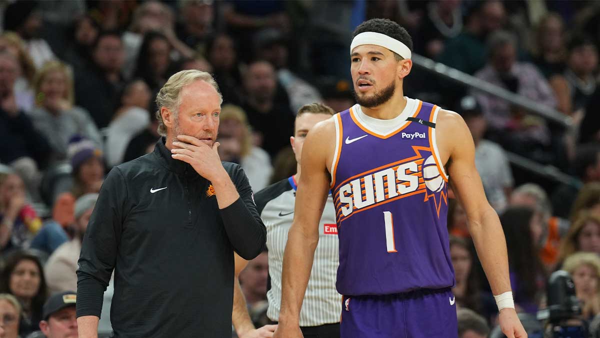 Phoenix Suns head coach Mike Budenholzer and Phoenix Suns guard Devin Booker (1) look on against the Denver Nuggets during the second half at Footprint Center. Mandatory Credit