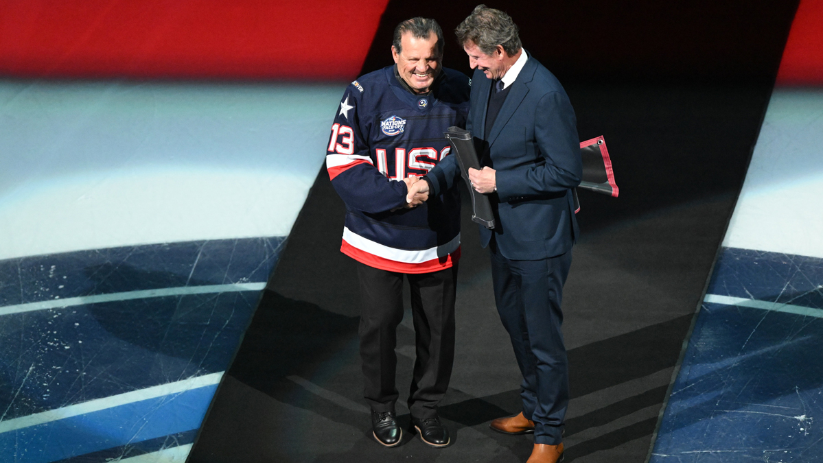 USA Former hockey player Mike Eruzione (left) and Former Canadian hockey player Wayne Gretzky stand on the ice for the puck drop prior to the game against Team USA and Team Canada during the 4 Nations Face-Off ice hockey championship game at TD Garden. 