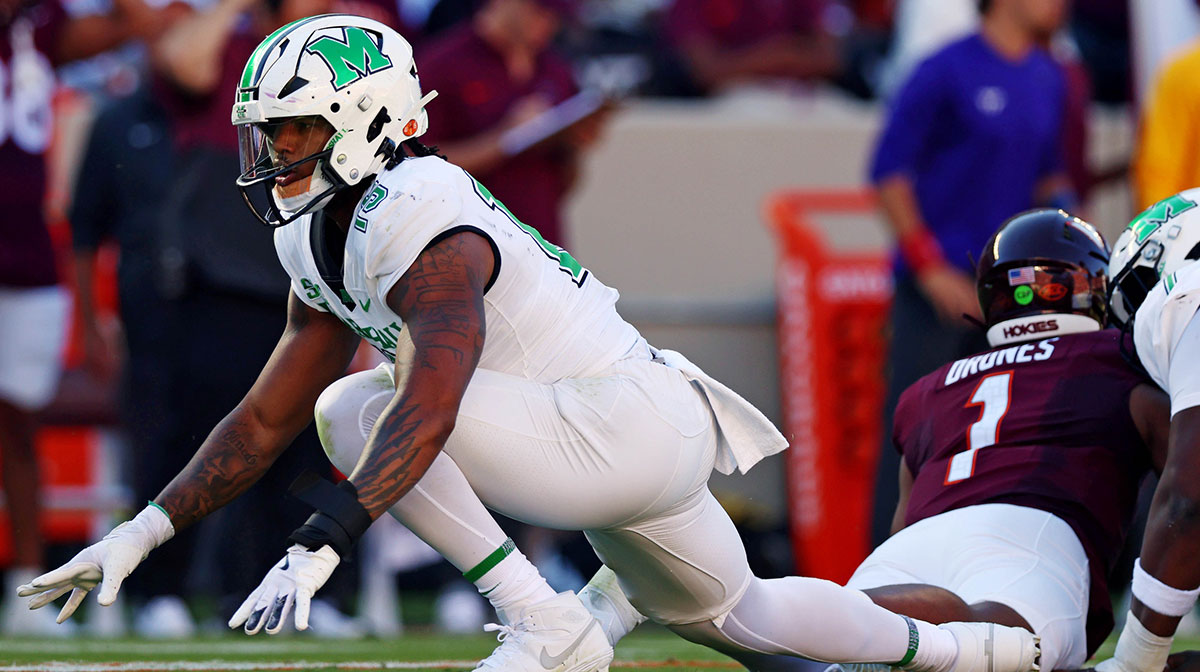2025 NFL Draft prospect Marshall Thundering Herd defensive lineman Mike Green (15) celebrates after sacking Virginia Tech Hokies quarterback Kyron Drones (1) during the first quarter at Lane Stadium.