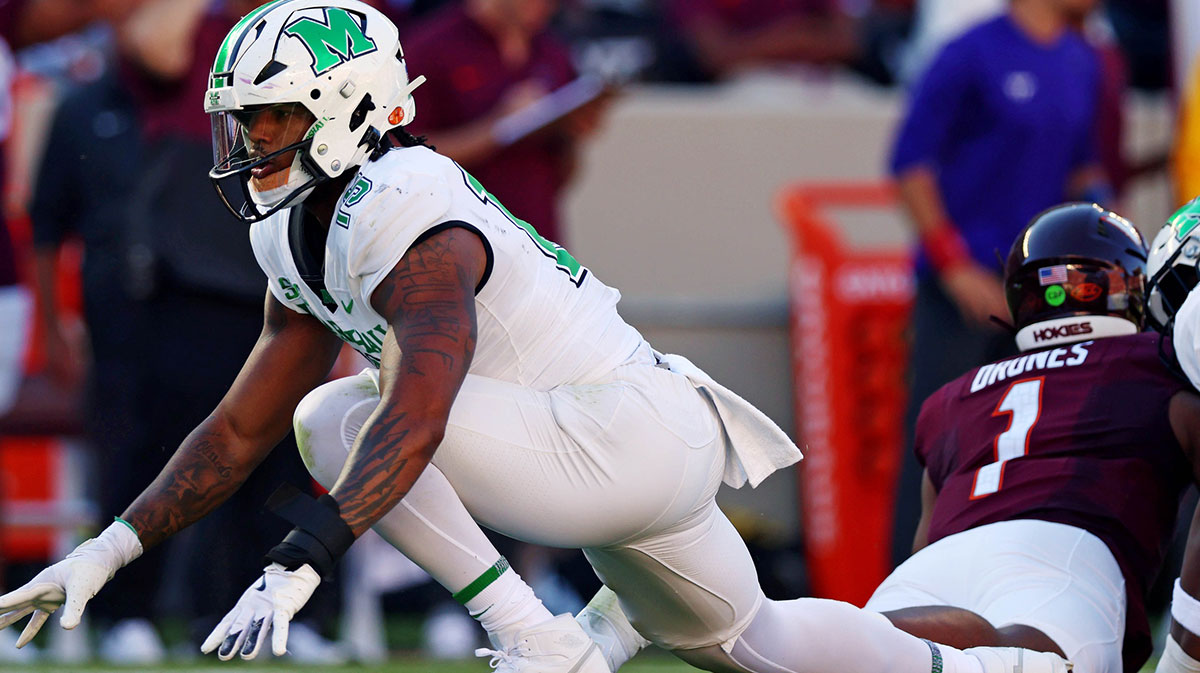 Marshall Thundering Herd defensive lineman Mike Green (15) celebrates after sacking Virginia Tech Hokies quarterback Kyron Drones (1) during the first quarter at Lane Stadium.