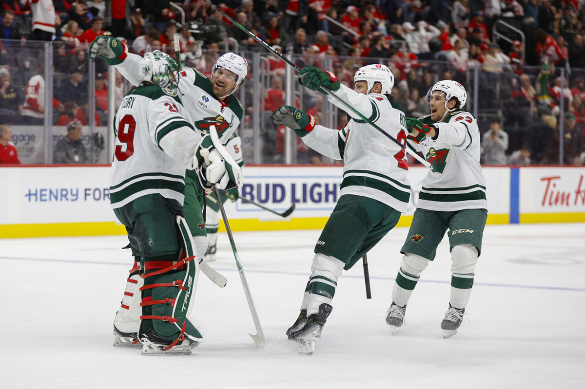 Minnesota Wild goaltender Marc-Andre Fleury (29) is congratulated by teammates at the end of overtime at Little Caesars Arena.