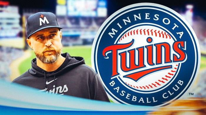 Rocco Baldelli looking excited next to a Twins logo