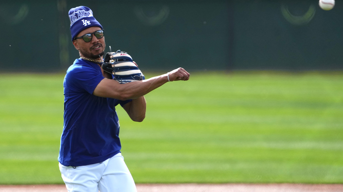 Los Angeles Dodgers shortstop Mookie Betts (50) throws during a Spring Training workout at Camelback Ranch.