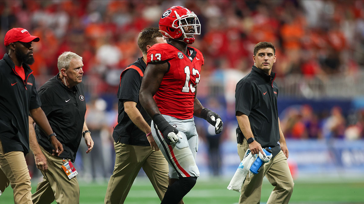 Georgia Bulldogs defensive lineman Mykel Williams (13) goes off the field with an injury against the Clemson Tigers in the third quarter at Mercedes-Benz Stadium