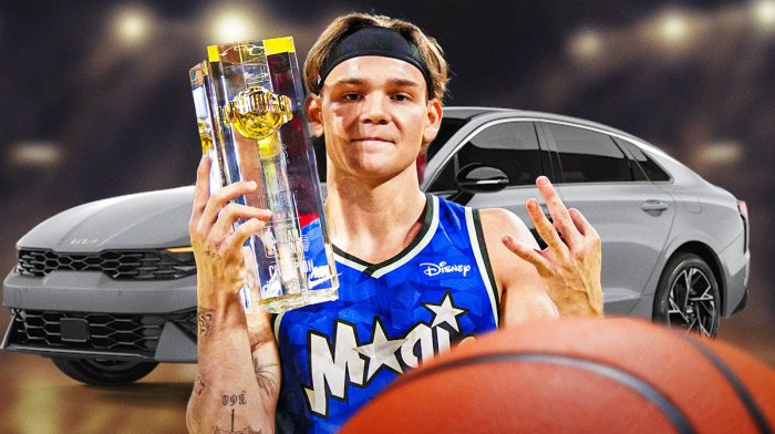 Mac McClung in a Magic jersey with a KIA car in the picture