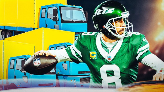 Former New York Jets quarterback Aaron Rodgers with moving trucks behind him