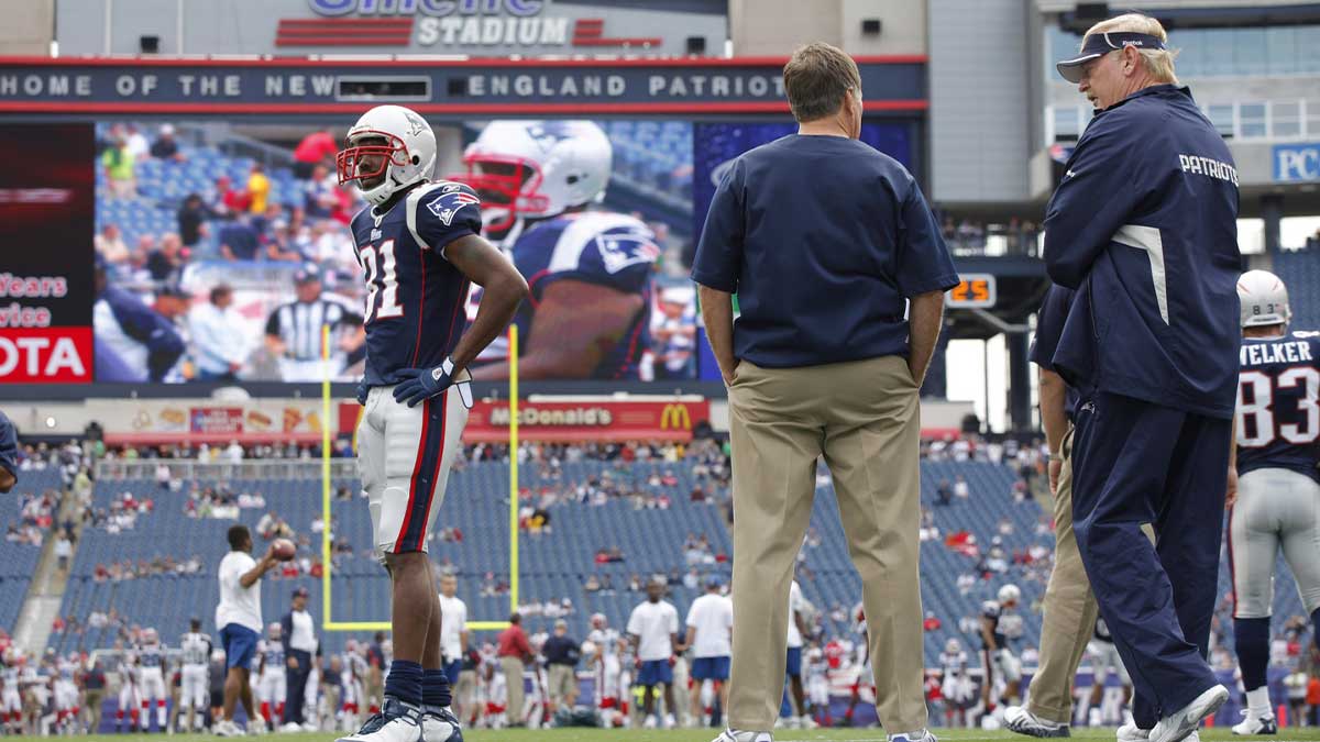 New England Patriots wide receiver Randy Moss (81) warms up before the start of the game as head coach Bill Belichick looks on against the Buffalo Bills at Gillette Stadium.