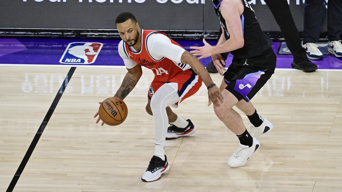 LA Clippers guard Norman Powell (24) dribbles against Utah Jazz guard/forward Svi Mykhailiuk (19) during the second half at the Delta Center.