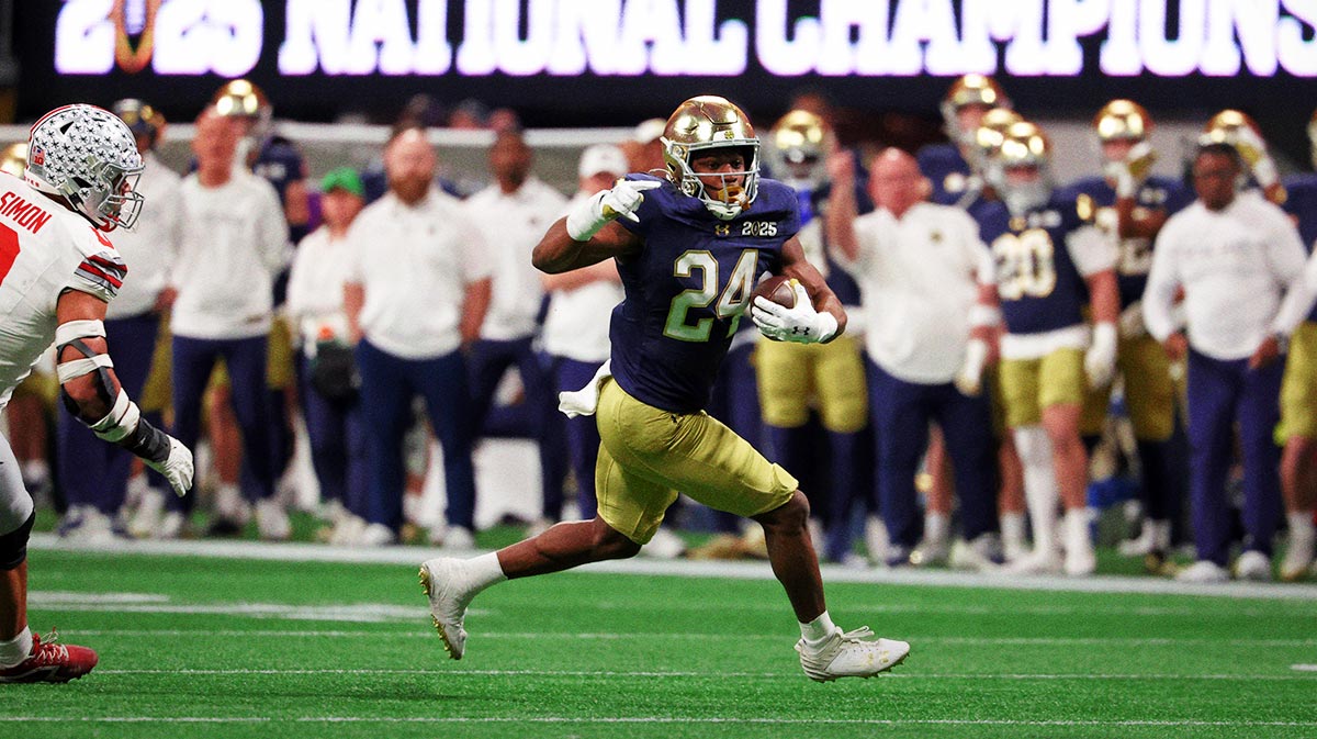 Notre Dame Fighting Irish running back Jadarian Price (24) runs with the ball against the Ohio State Buckeyes during the first half the CFP National Championship college football game at Mercedes-Benz Stadium.