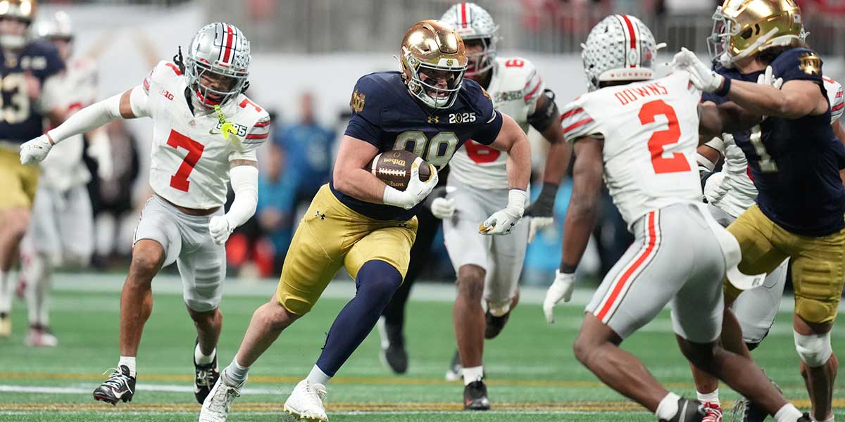 Notre Dame Fighting Irish tight end Mitchell Evans (88) runs the ball against the Ohio State Buckeyes in the second half in the CFP National Championship college football game at Mercedes-Benz Stadium.