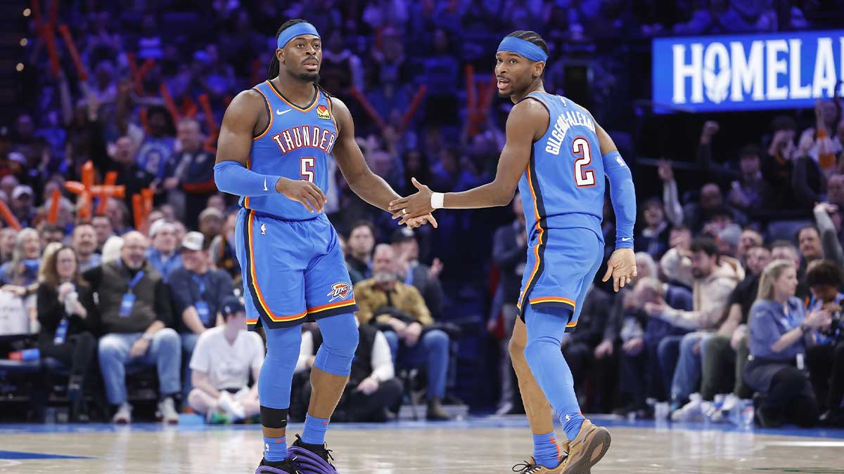 Oklahoma City Thunder guard Luguentz Dort (5) and guard Shai Gilgeous-Alexander (2) celebrate after a play against the Miami Heat during the second half at Paycom Center.