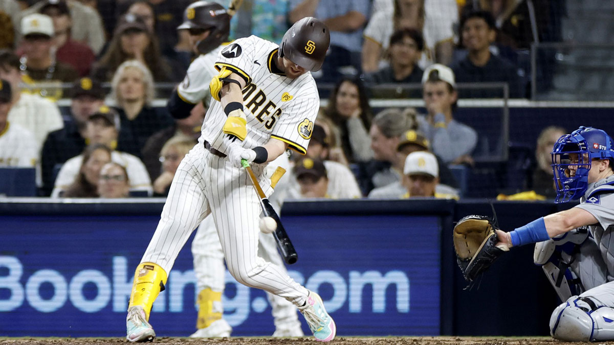 San Diego Padres first baseman Jake Cronenworth (9) triples in the seventh inning against the Los Angeles Dodgers during game four of the NLDS for the 2024 MLB Playoffs at Petco Park.