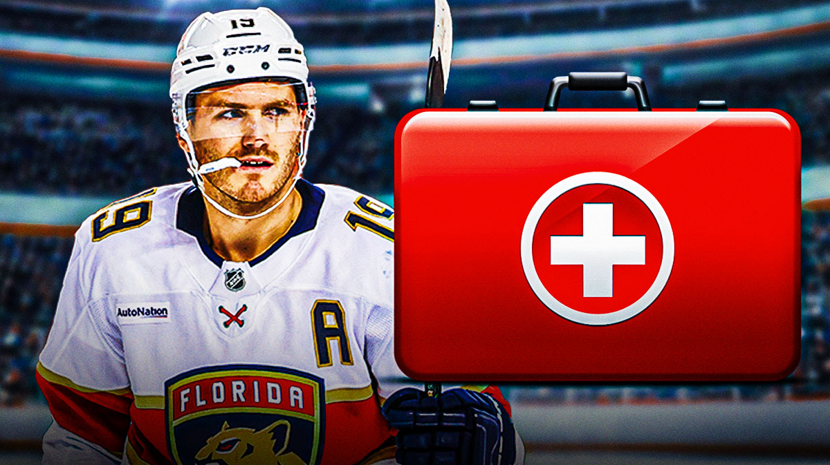 Matthew Tkachuk looking stern with first aid kit in image, hockey rink in background