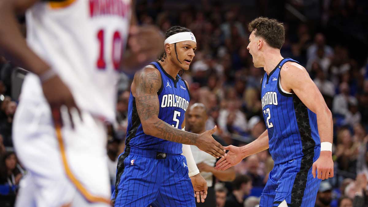 Orlando Magic forward Paolo Banchero (5) and forward Franz Wagner (22) celebrate after a basket against the Golden State Warriors in the second quarter at Kia Center.