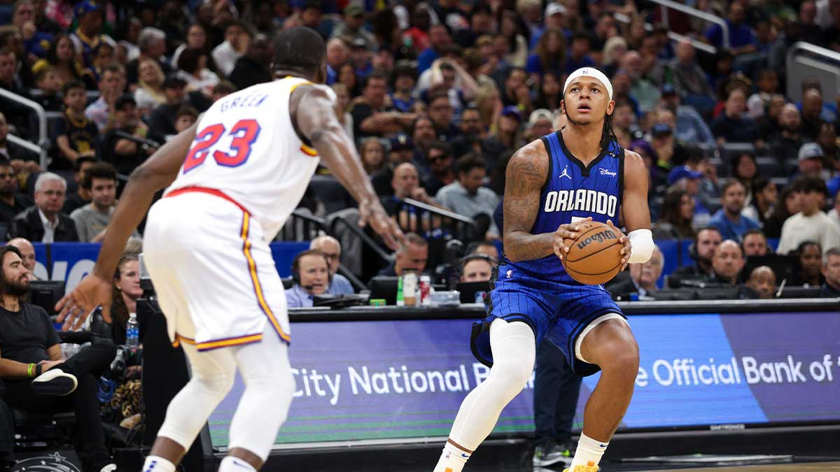 Orlando Magic forward Paolo Banchero (5) shoots a three point shot against the Golden State Warriors in the second quarter at Kia Center.