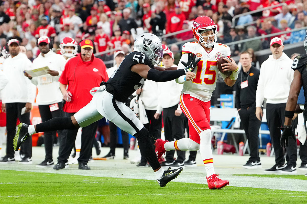 Kansas City Chiefs quarterback Patrick Mahomes (15) is shoved out of bounds by Las Vegas Raiders defensive end Malcolm Koonce (51) during the second quarter at Allegiant Stadium.