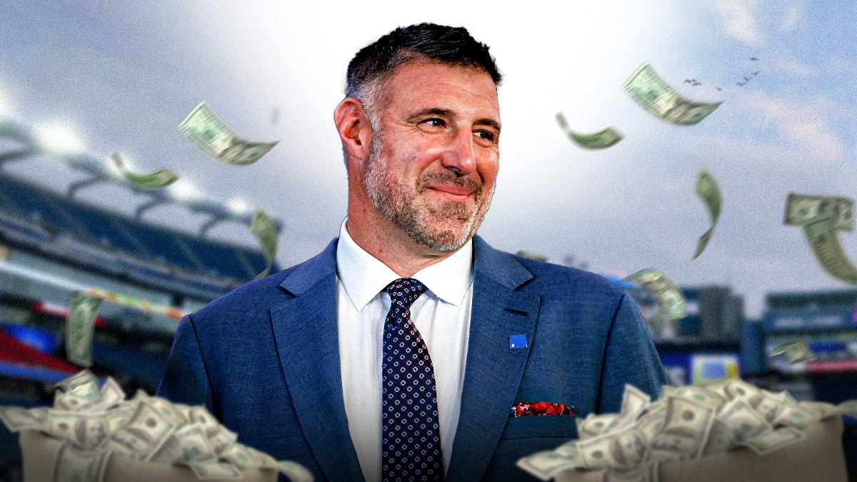 Mike Vrabel with money bags around him