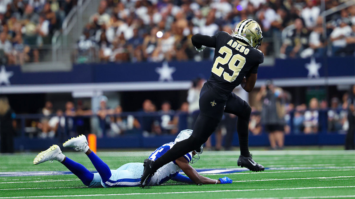 Sep 15, 2024; Arlington, Texas, USA; New Orleans Saints cornerback Paulson Adebo (29) intercepts a ball intended for Dallas Cowboys wide receiver Jalen Brooks (83) during the first half at AT&T Stadium. 