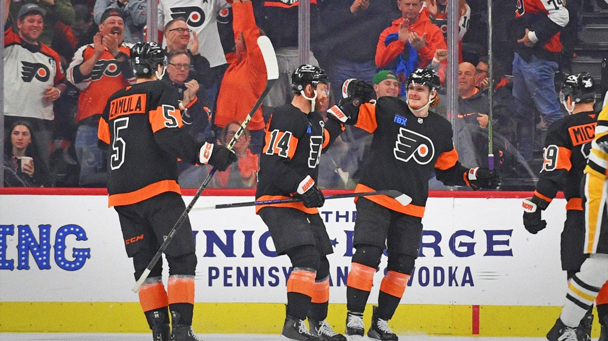 Philadelphia Flyers right wing Owen Tippett (74) celebrates his goal with center Sean Couturier (14) and defenseman Egor Zamula (5) against the Pittsburgh Penguins during the third period at Wells Fargo Center.