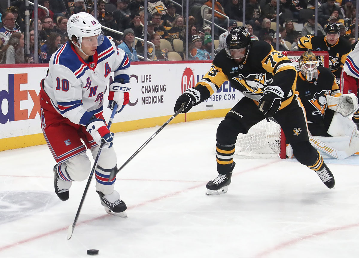 New York Rangers left wing Artemi Panarin (10) moves the puck against Pittsburgh Penguins defenseman P.O Joseph (73) during the third period at PPG Paints Arena.