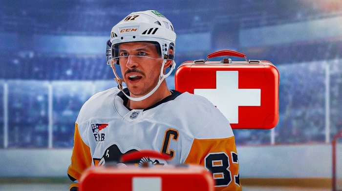 Sidney Crosby looking stern, first aid kit, hockey rink in background