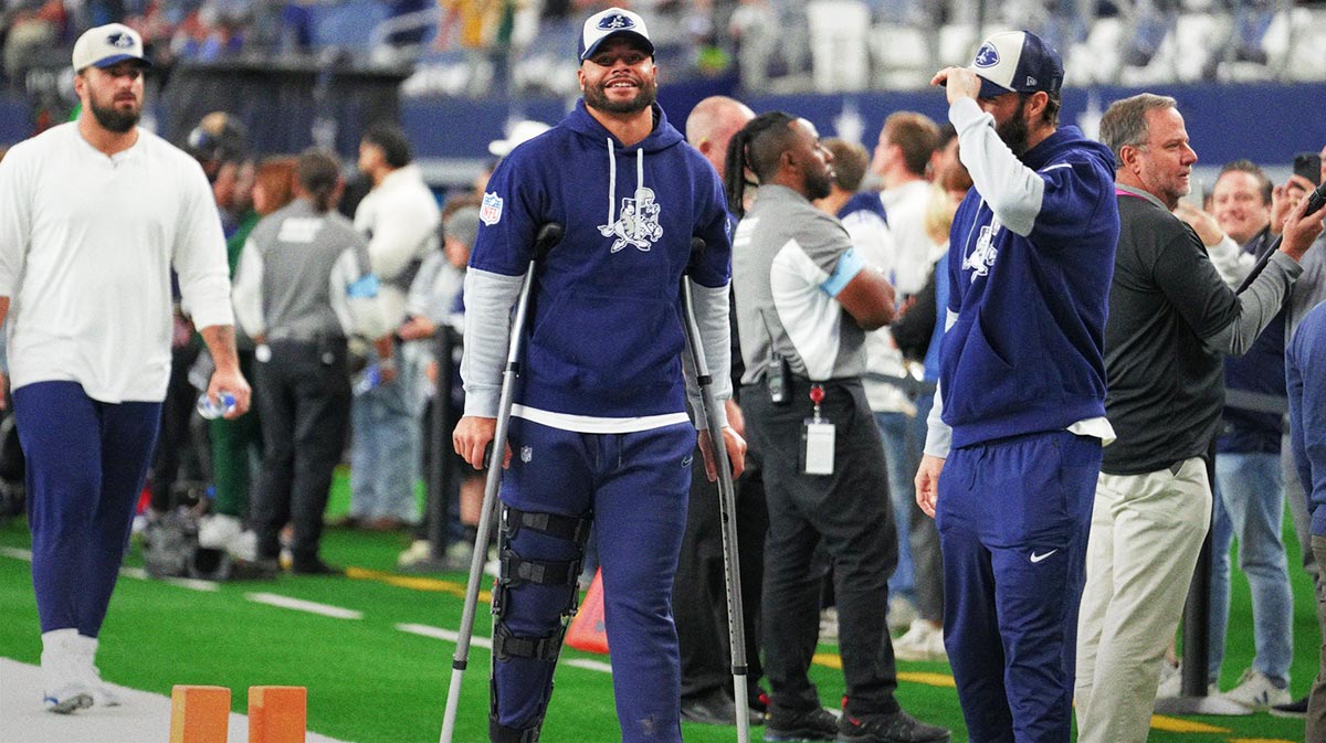 Dallas Cowboys Quarterback Dak Prescott (left) stands on crutches before the game against New York giants at the AT & T Stadium.