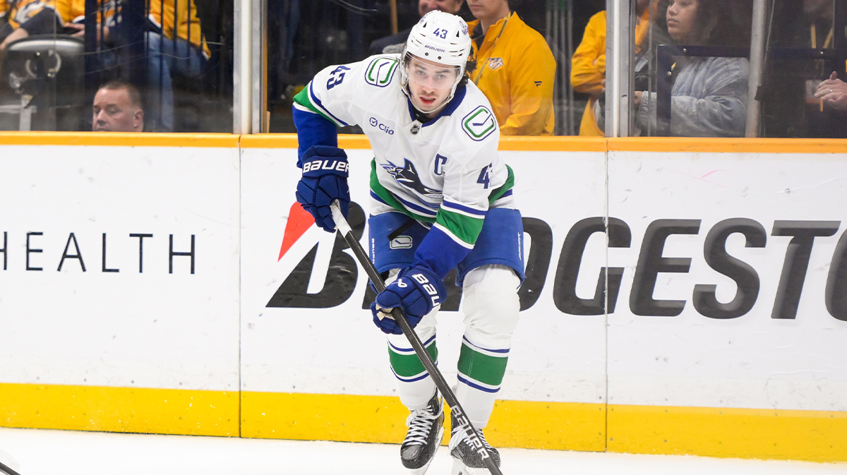 Vancouver Canucks Defenseman Kuinn Hughes (43) Skates behind Nashville Networks during the third period in Bridgestone Arena. 