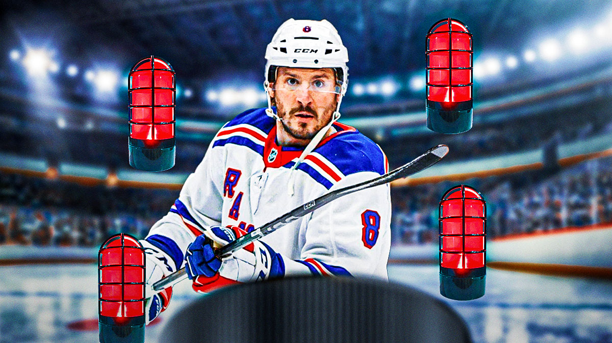 J.T. Miller in his new Rangers uniform with red goal lights around him