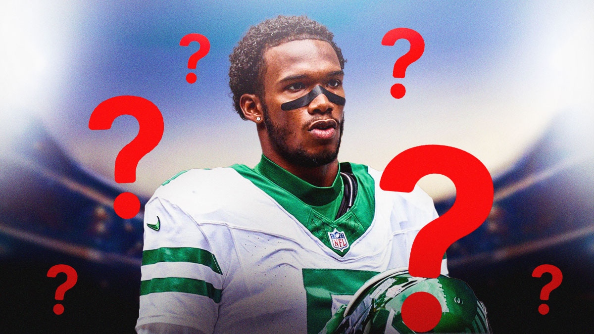 Garrett Wilson surrounded by ??? on an NFL field.