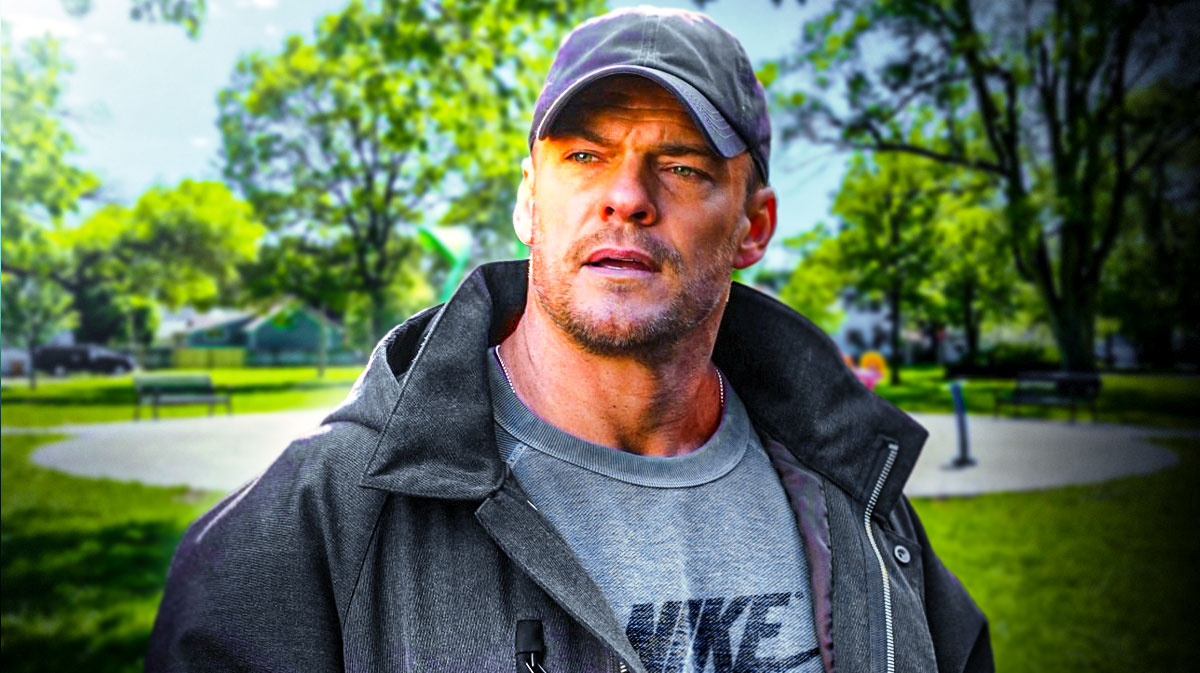 Reacher star Alan Ritchson in a park.