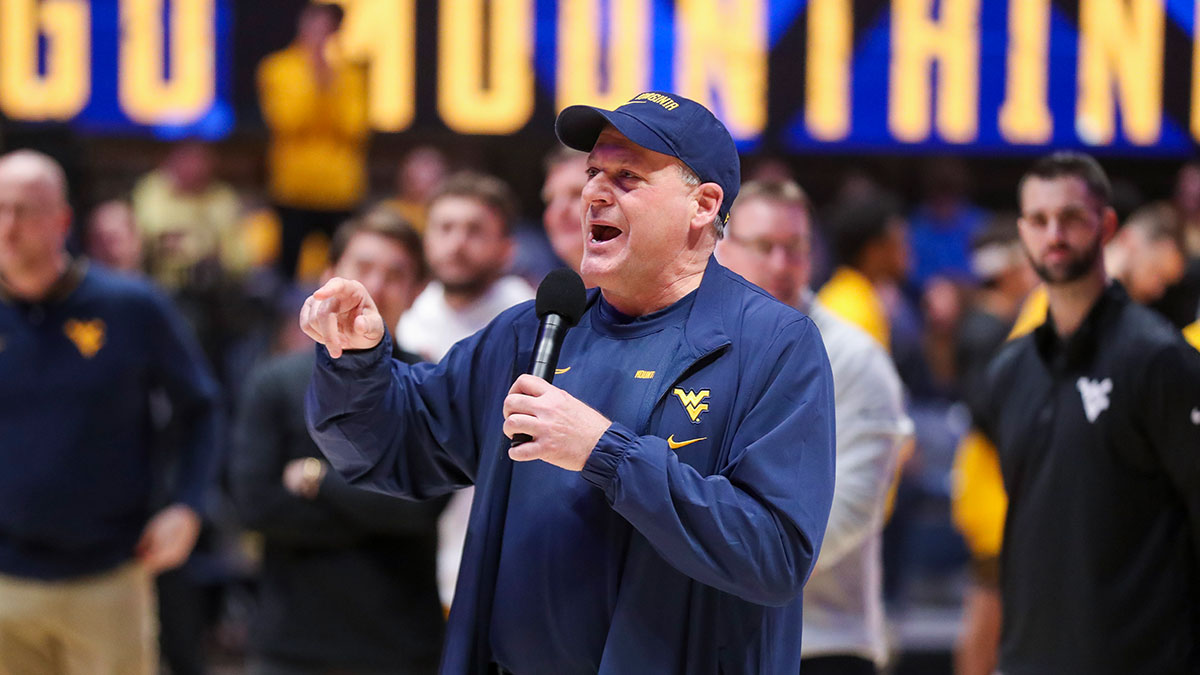 West Virginia Mountaineers head football coach Rich Rodriguez speaks to the crowd during a timeout during the first half against the Cincinnati Bearcats at WVU Coliseum.