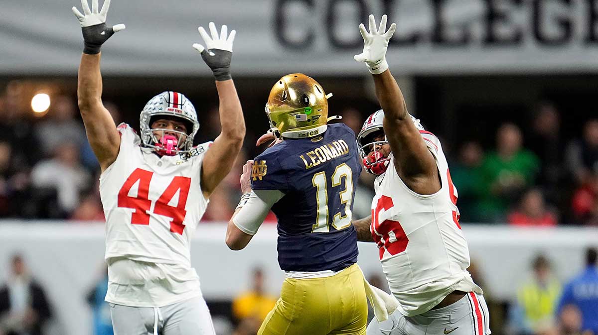 Notre Dame Fighting Irish quarterback Riley Leonard (13) throws the ball against Ohio State Buckeyes defensive end JT Tuimoloau (44) and Ohio State Buckeyes defensive end Eddrick Houston (96) in the fourth quarter during the College Football Playoff National Championship at Mercedes-Benz Stadium in Atlanta on January 20, 2025.
