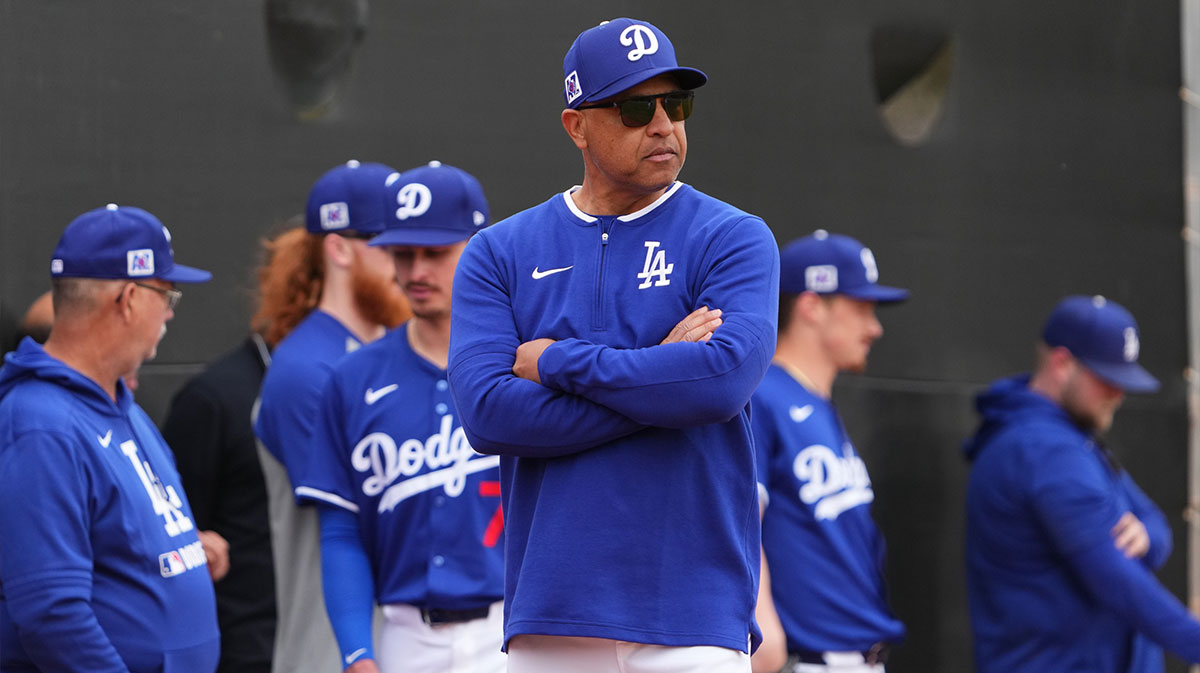 Los Angeles Dodgers manager Dave Roberts looks on during a Spring Training workout at Camelback Ranch.