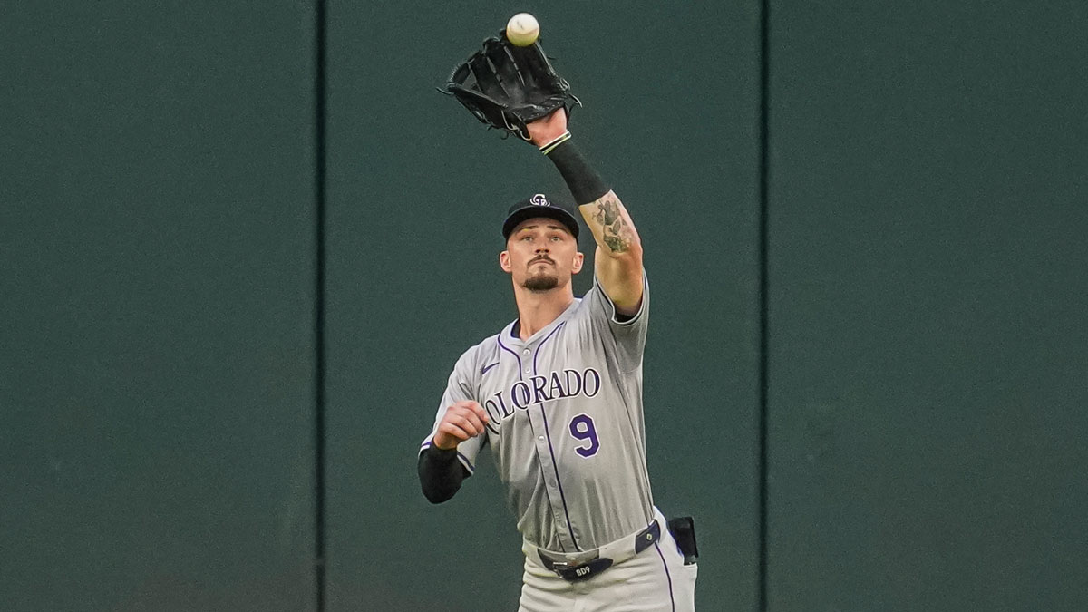 Colorado Rockies center fielder Brenton Doyle (9) catches a fly ball against the Atlanta Braves during the first inning at Truist Park.