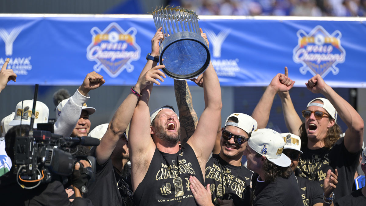 Los Angeles Dodgers starting pitcher Clayton Kershaw (22) lifts the World Series Championship Trophy during the team celebration at Dodger Stadium.