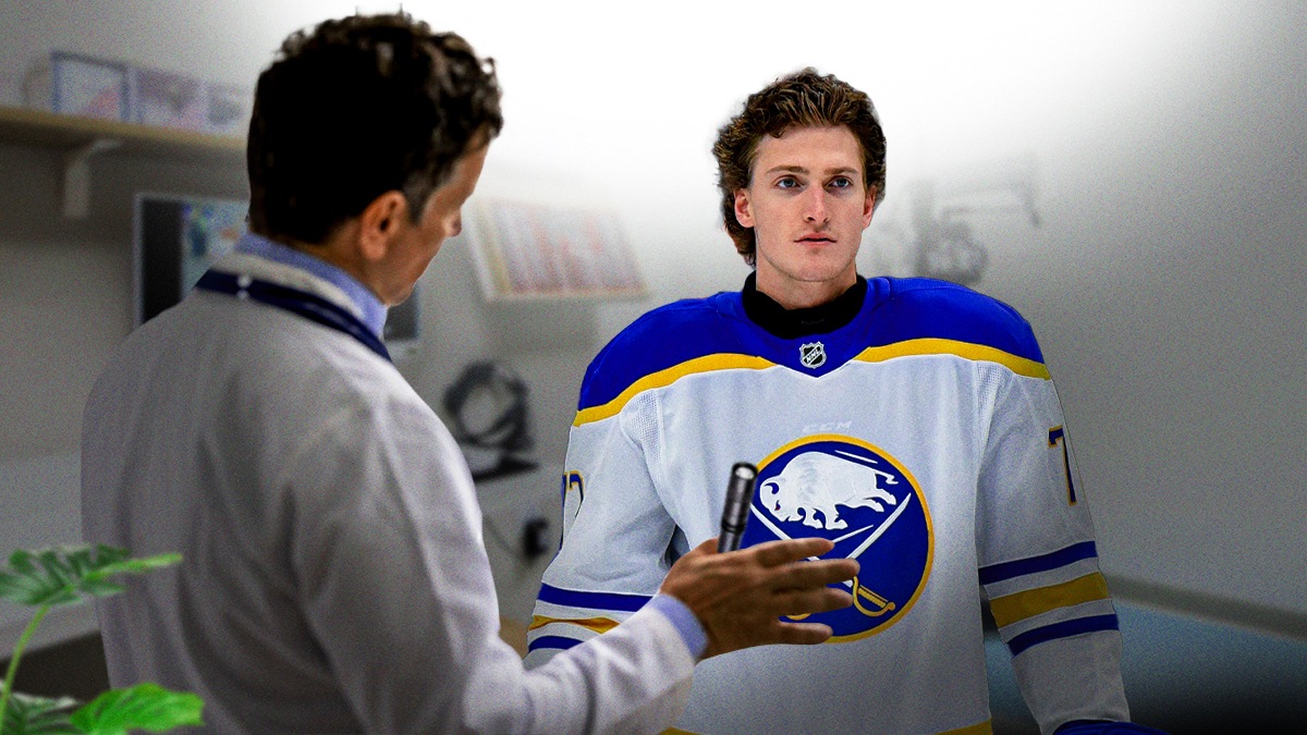 Sabres forward Tage Thompson next to a doctor with an eye flashlight