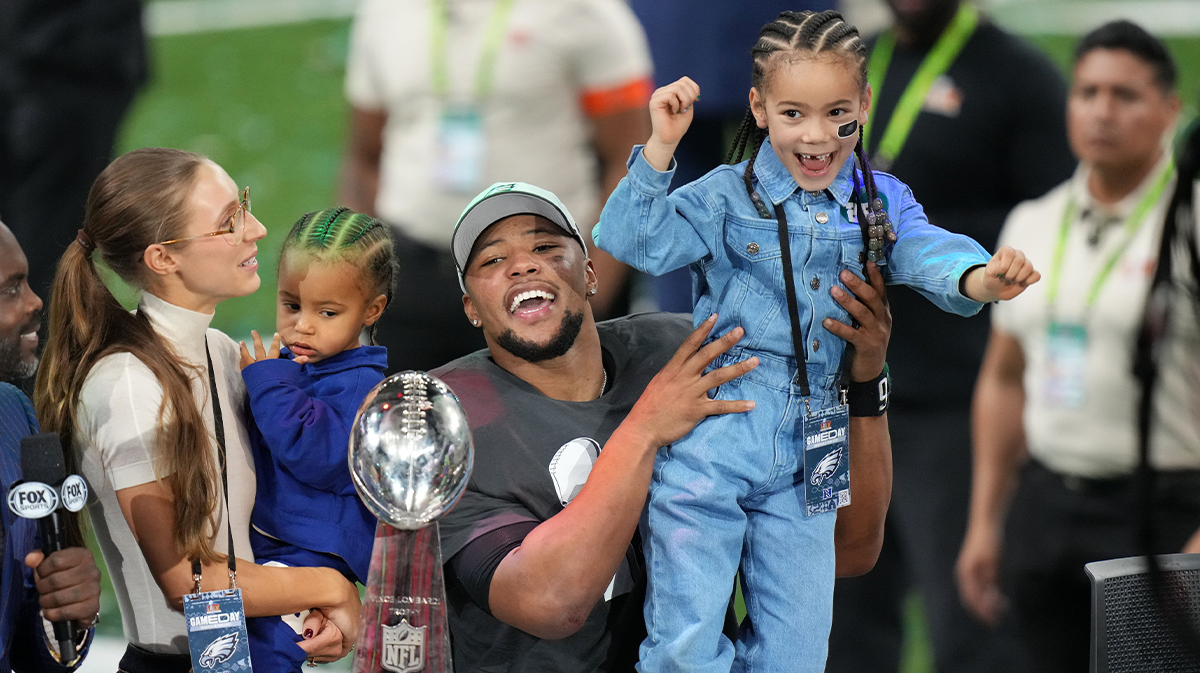 Philadelphia Eagles running back Saquon Barkley (26) talks to the media with his daughter, Jada, after defeating the Kansas City Chiefs in Super Bowl LIX at Caesars Superdome.