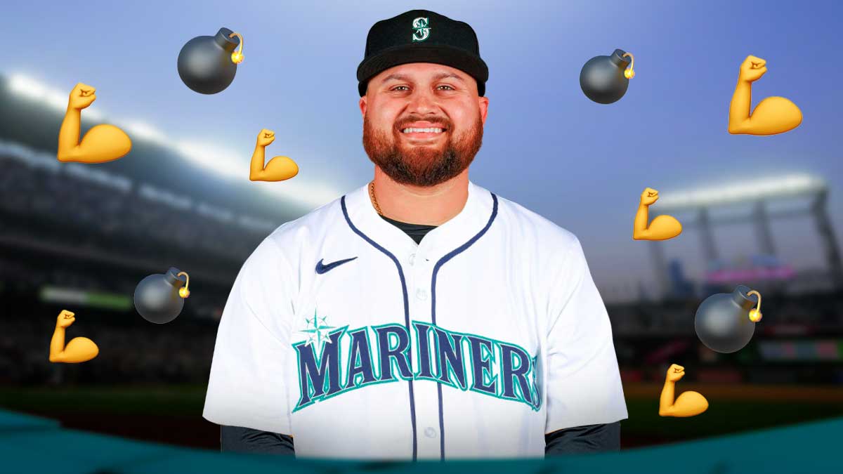 Rowdy Tellez in a Mariners uniform with a bomb emoji behind him. There is also the muscle emoji behind him.