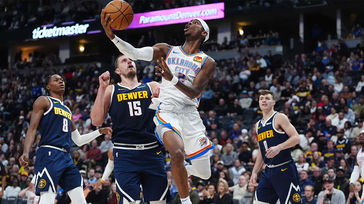 Oklahoma City Thunder guard Shai Gilgeous-Alexander (2) shoots the ball past Denver Nuggets center Nikola Jokic (15) in the second quarter at Ball Arena. 