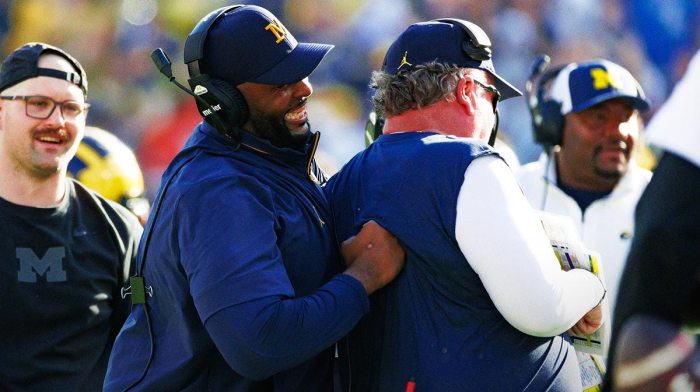 Michigan Wolverines head coach Sherrone Moore smiles while joking with a defensive coach against the Alabama Crimson Tide during the second half at Raymond James Stadium.