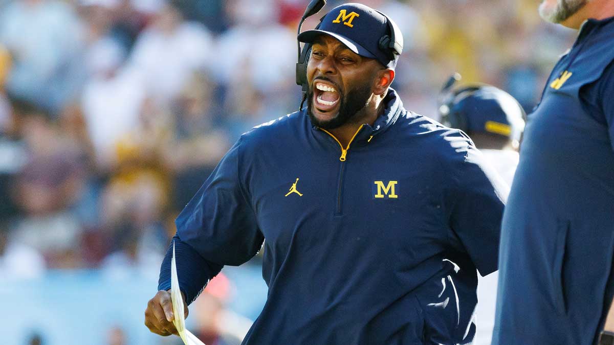 Michigan Wolverines head coach Sherrone Moore screams from the sideline against the Alabama Crimson Tide during the second half at Raymond James Stadium.