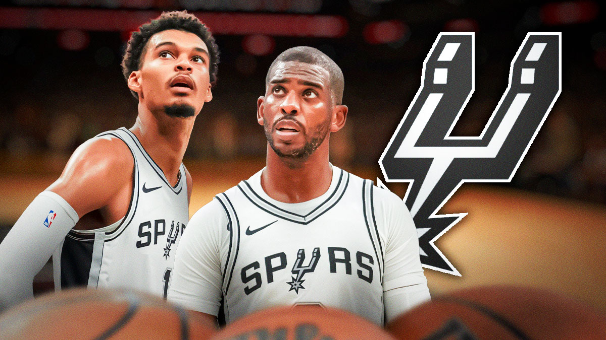 Spurs All-Star Victor Wembanyama next to Spurs point guard Chris Paul with the Spurs logo in the background
