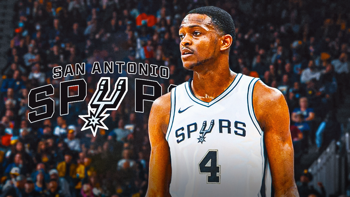 De'Aaron Fox in Spurs #4 jersey next to Spurs logo