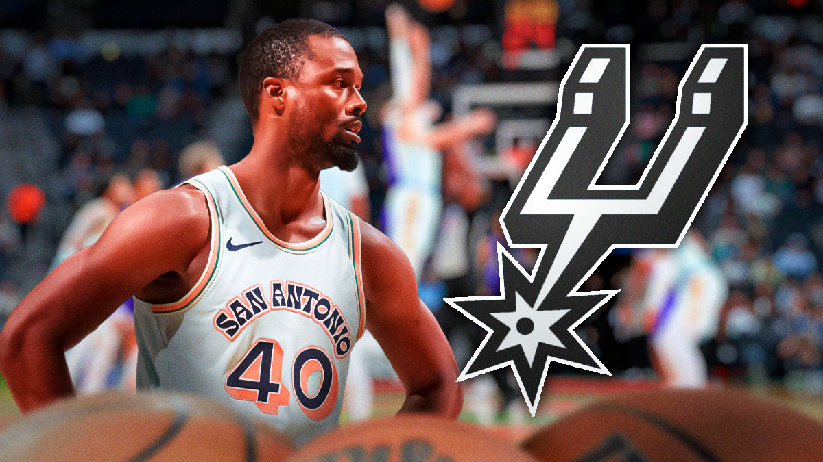 Harrison Barnes looking concerned next to a Spurs logo