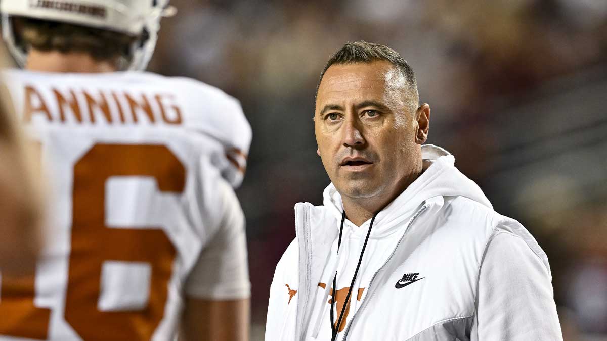 Texas Longhorns head coach Steve Sarkisian speaks with quarterback Arch Manning (16) during warm ups against the Texas A&M Aggies at Kyle Field.