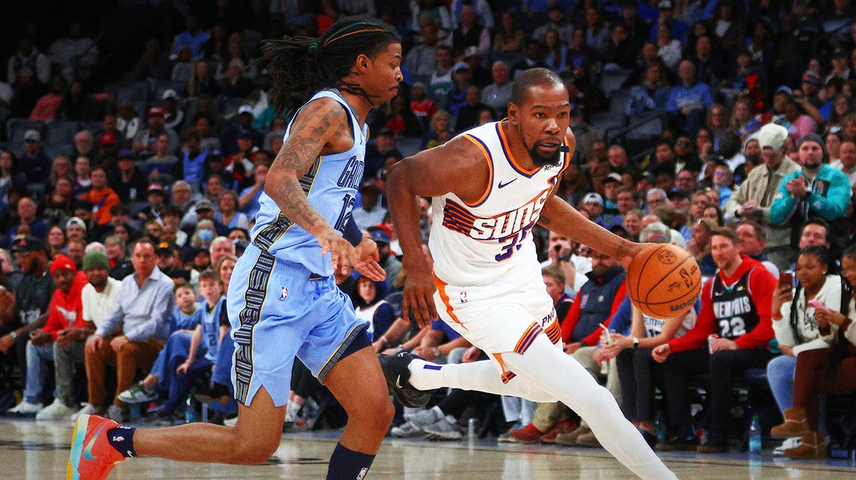 Suns forward Kevin Durant (35) drives to the basket as Memphis Grizzlies guard Ja Morant (12) defends during the fourth quarter at FedExForum