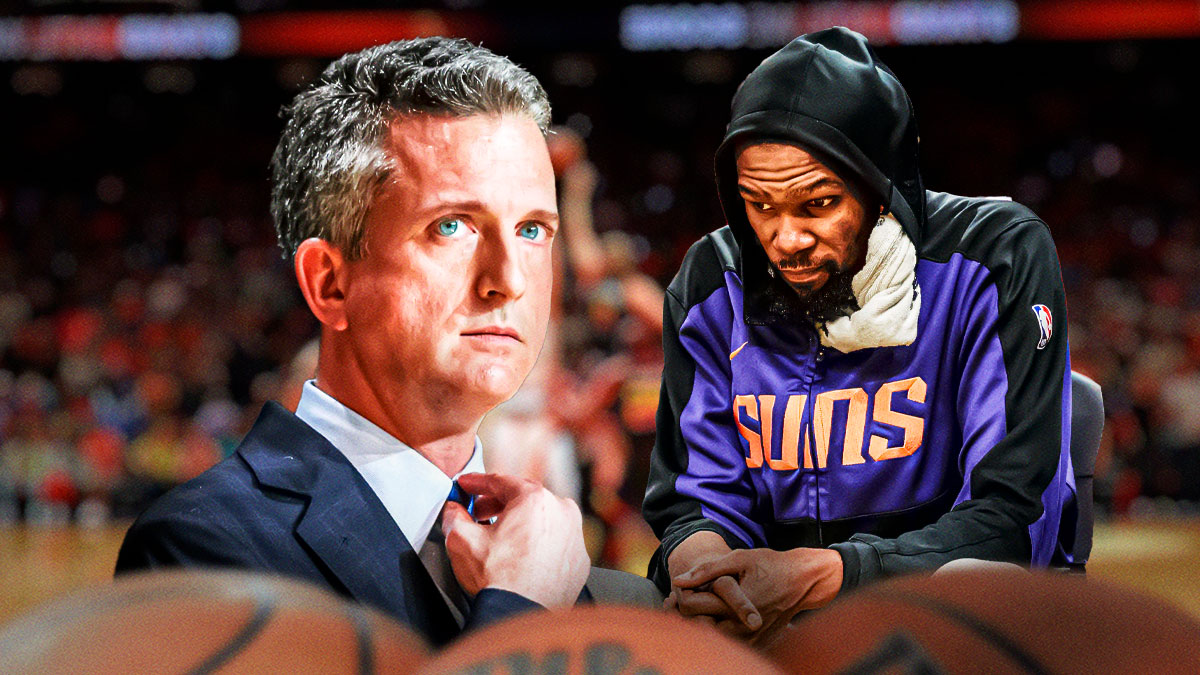 Kevin Durant looking sad while sitting on the Suns bench, and Bill Simmons looking concerned and is next to Durant.