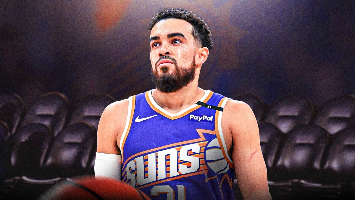 Suns point guard Tyus Jones with a tear going down his face, and a picture of an empty Suns bench behind him.