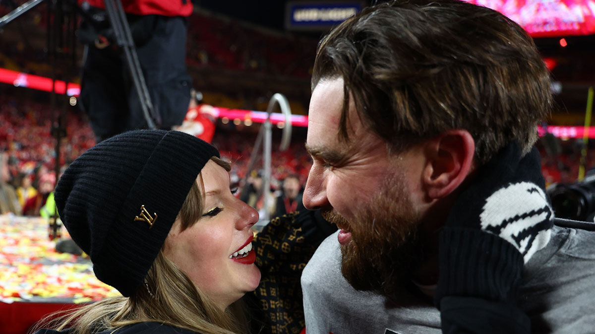 Recording artist Taylor Swift and Kansas City Chiefs tight end Travis Kelce (87) react after the AFC Championship game against the Buffalo Bills at GEHA Field at Arrowhead Stadium.